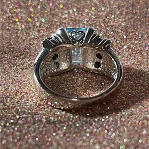 Sterling silver ring with a light blue stone with dark blue stones